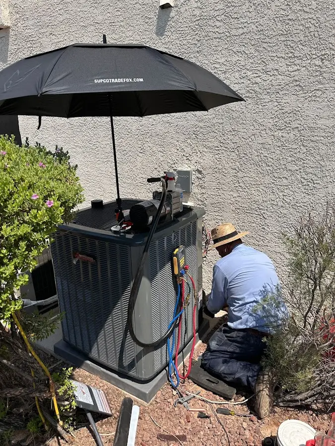 HVAC technician performing outdoor AC maintenance in Country Club Hills